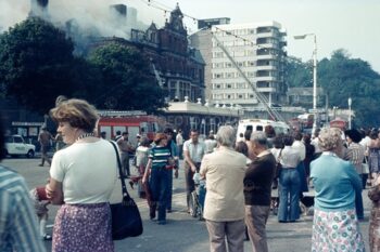 People in street watching the fire at the Esplanade Hotel, Penarth, South Wales 1977