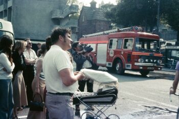 People in street watching the fire at the Esplanade Hotel, Penarth, South Wales 1977