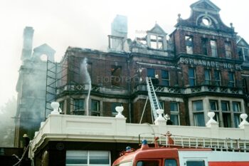 Fire fighters on long ladders tackle the fire at the Esplanade Hotel Fire, Penarth, South Wales 1977