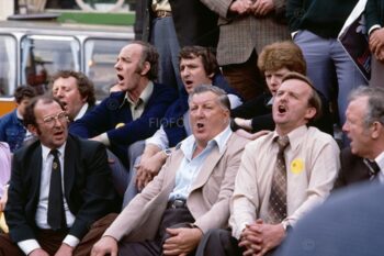 Several members of Risca Male Voice Choir from South Wales, UK. Public singing on steps of Anteros statue (also known as Eros) Piccadilly Circus, London, 1980.