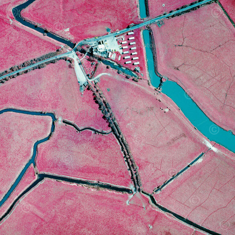 Aerial infra-red photograph of farmland and canal waterways in West Sussex, England, UK.
