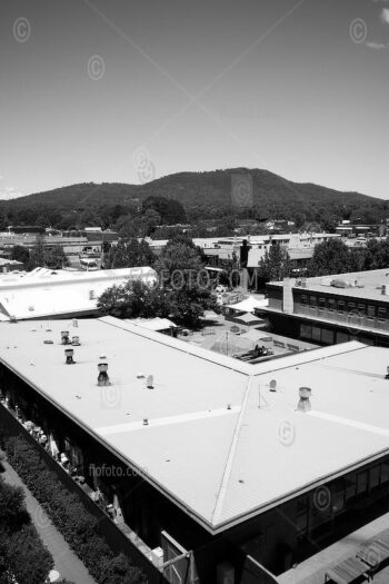 Canberra cityscape and topographics, Australia. View over rooftops in Dickson towards the hills at Mount Ainslie in the south east, ACT, Australia.
