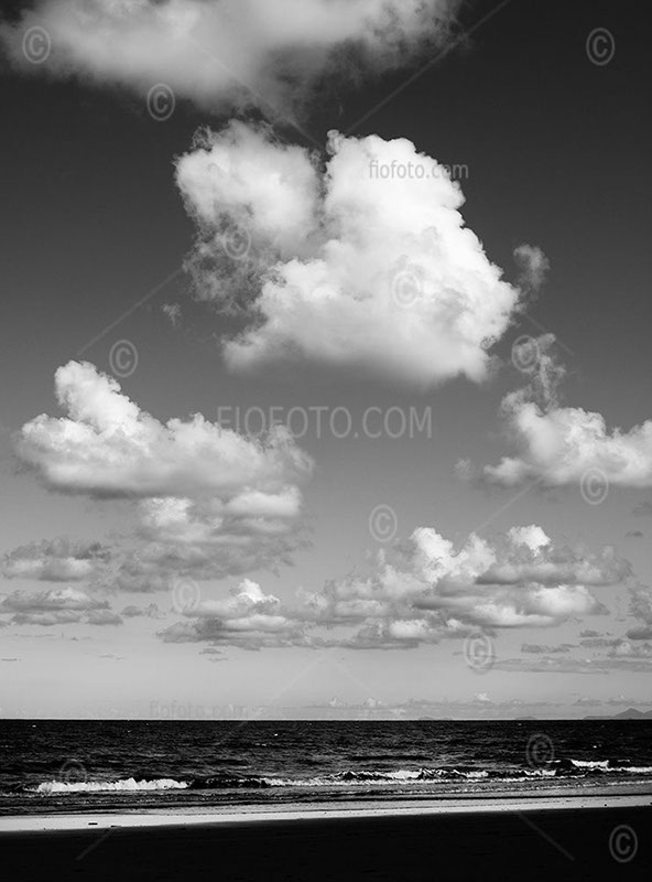 View out to Coral Sea from Four Mile Beach, Port Douglas, NE Qld. Shows ocean and fluffy clouds. Beneath those waves is the endangered Great Barrier Reef.