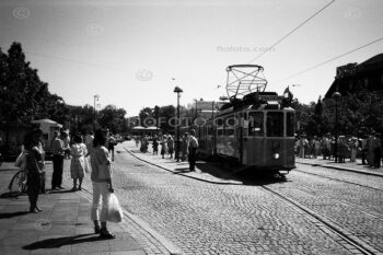Street scene in central Gothenburg, Sweden. Passengers on pavement and tram. Tram lines on an urban road. Photo circa 1985.