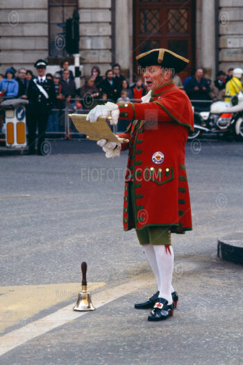 Town Crier, also known as a Bell Man, at the Lord Mayor's Show in London, with a coat badge reading "Red Deer Royals".