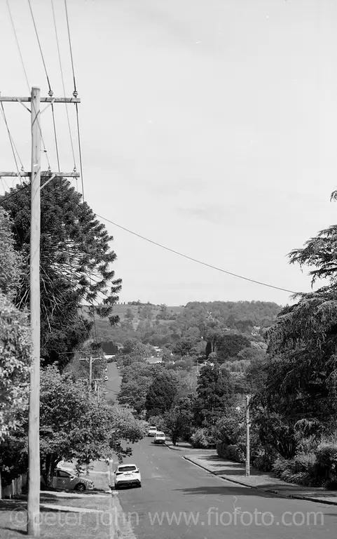 View down Shepherd Street, Bowral, towards Oxley Hill, NSW under a cloudy sky. The road and surrounding landscape are visible. Photo 2022. Ref: 919-18