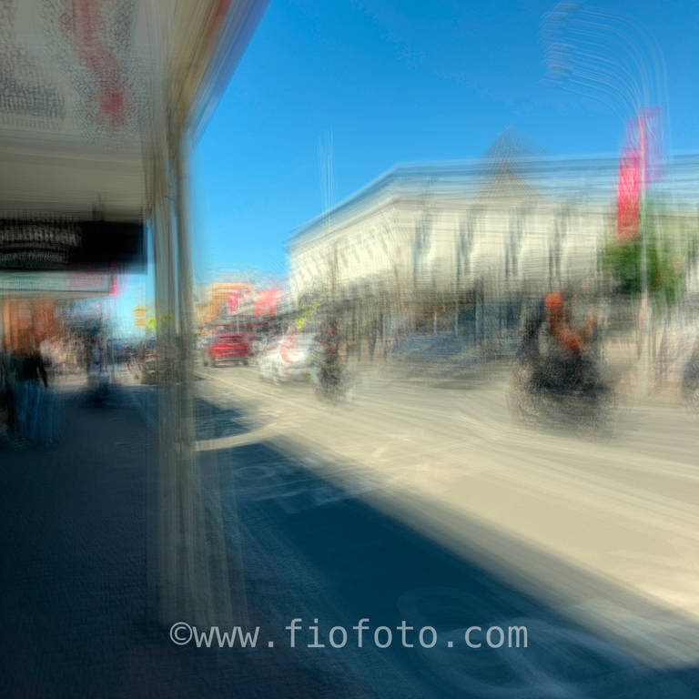 Blurred, long exposure image of pedestrians walking in street, Bowral, NSW